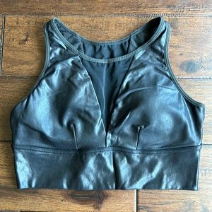 SPANX faux leather sports bra with V cut mesh details.